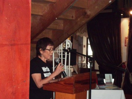 Joan Dayal delivers opening remarks to the audience.